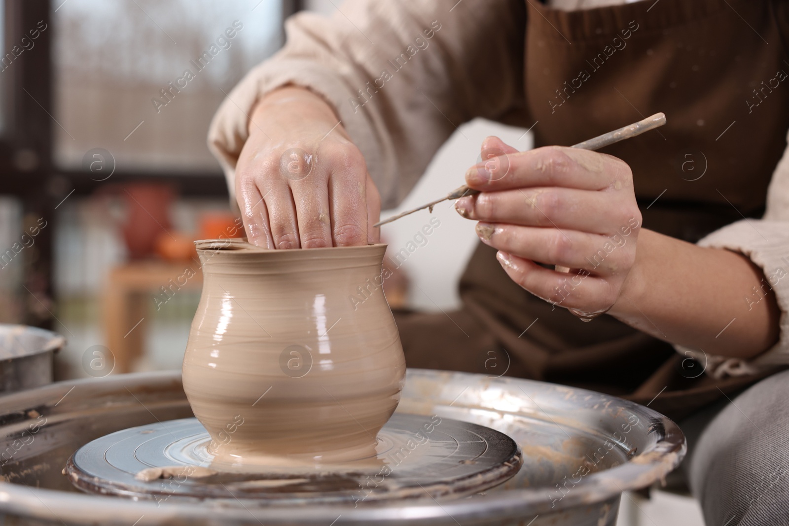 Photo of Hobby and craft. Woman making pottery indoors, closeup