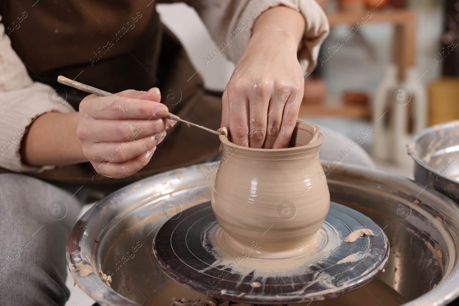 Photo of Hobby and craft. Woman making pottery indoors, closeup