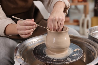 Photo of Hobby and craft. Woman making pottery indoors, closeup