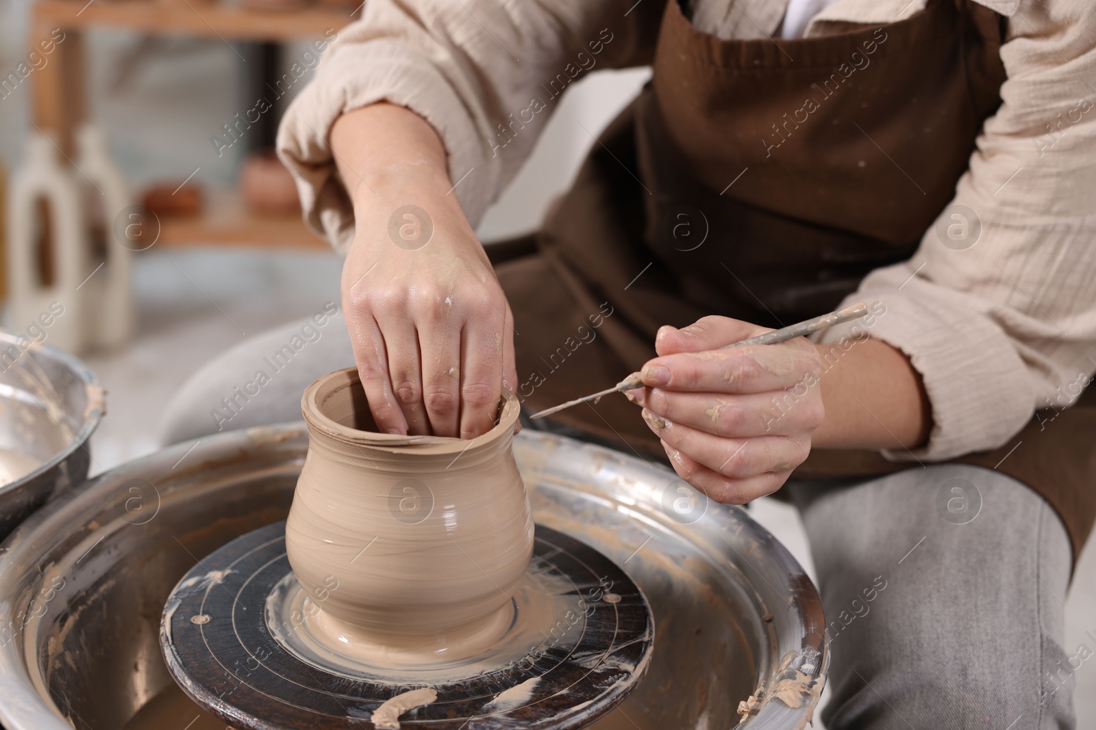 Photo of Hobby and craft. Woman making pottery indoors, closeup