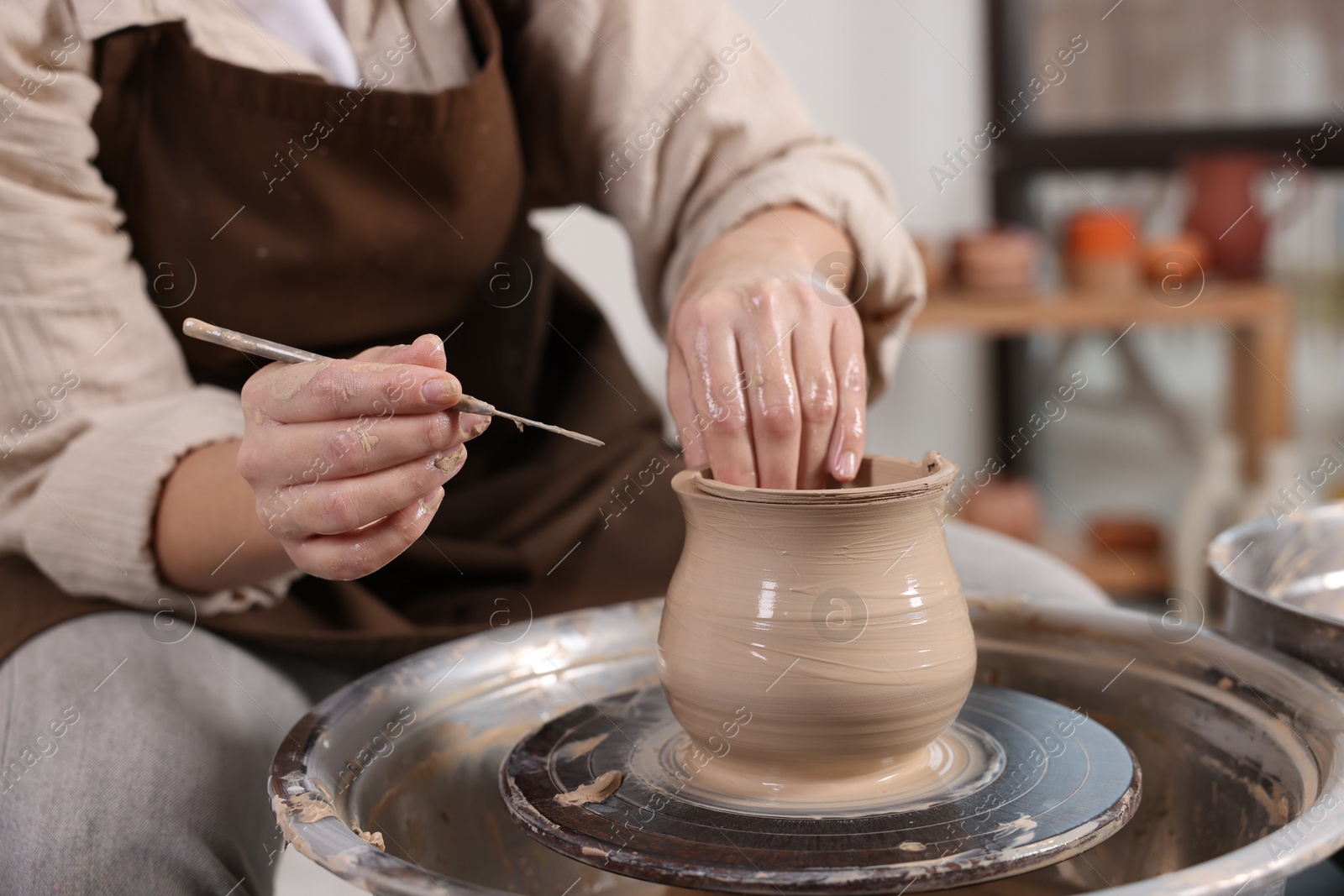 Photo of Hobby and craft. Woman making pottery indoors, closeup