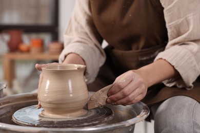 Photo of Hobby and craft. Woman making pottery indoors, closeup