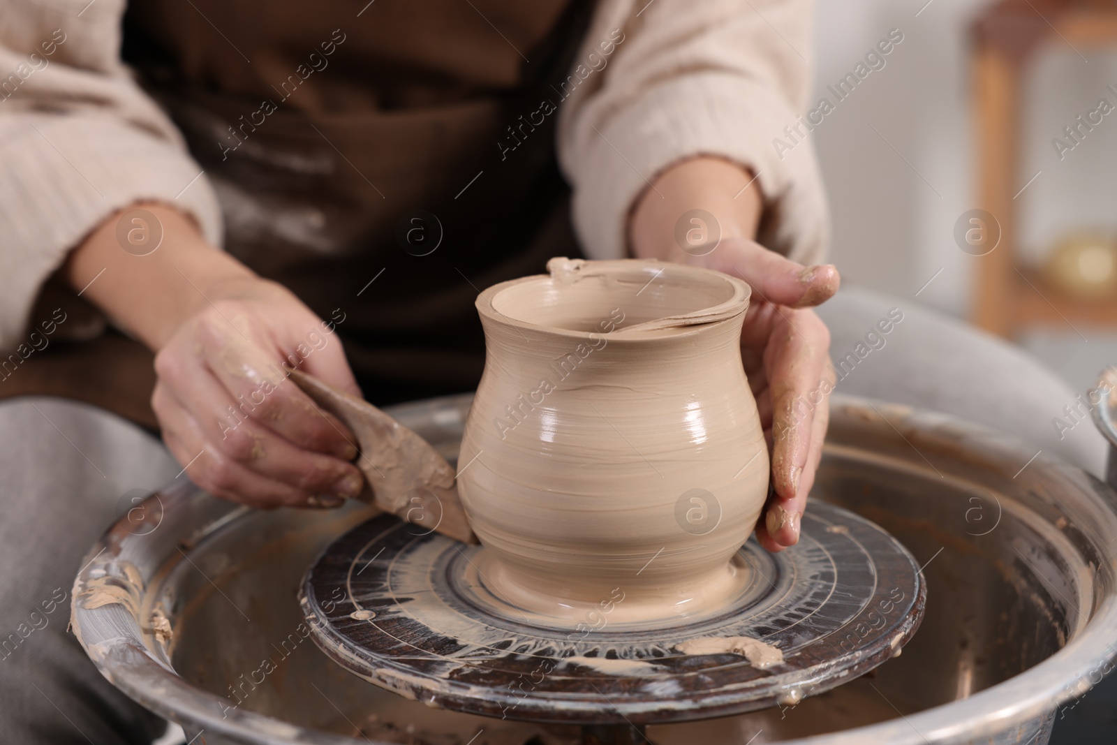 Photo of Hobby and craft. Woman making pottery indoors, closeup