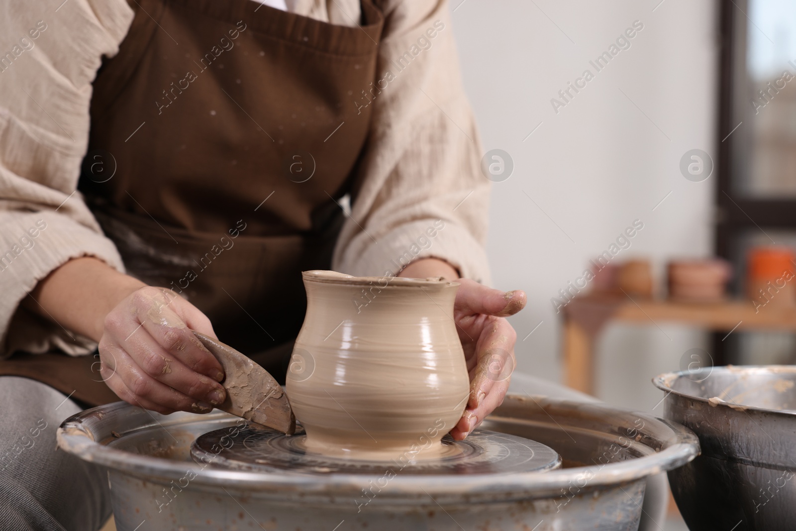 Photo of Hobby and craft. Woman making pottery indoors, closeup