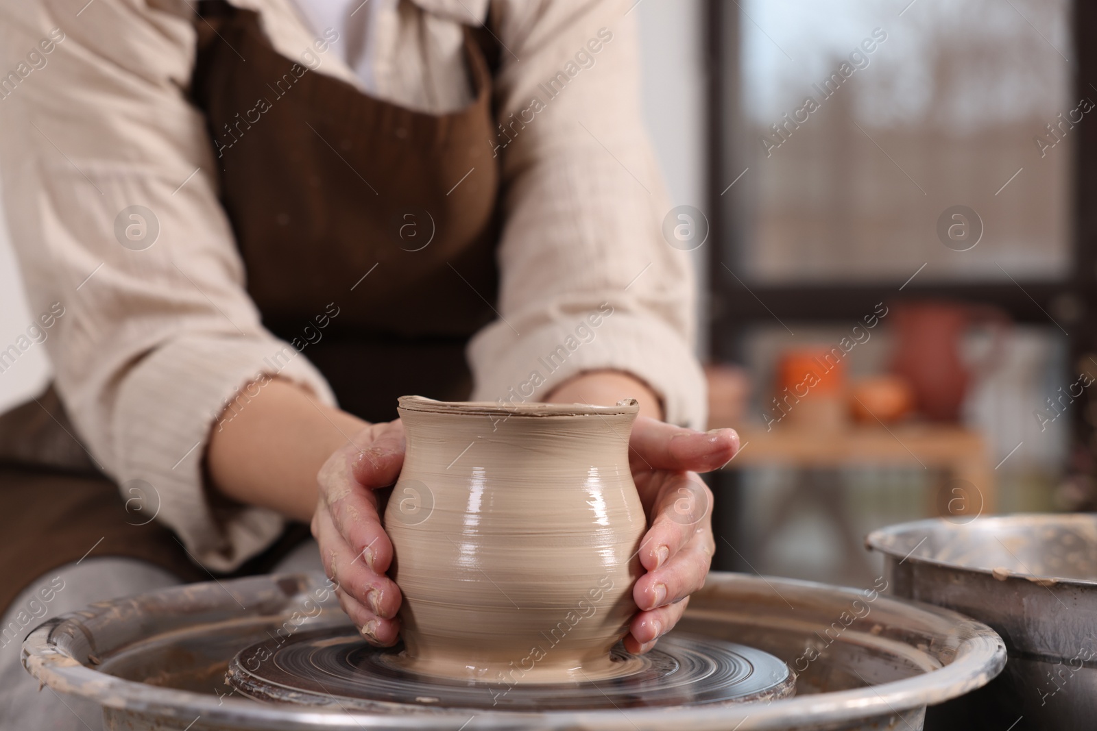 Photo of Hobby and craft. Woman making pottery indoors, closeup