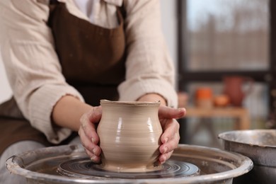 Photo of Hobby and craft. Woman making pottery indoors, closeup