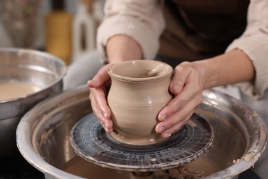 Photo of Hobby and craft. Woman making pottery indoors, closeup