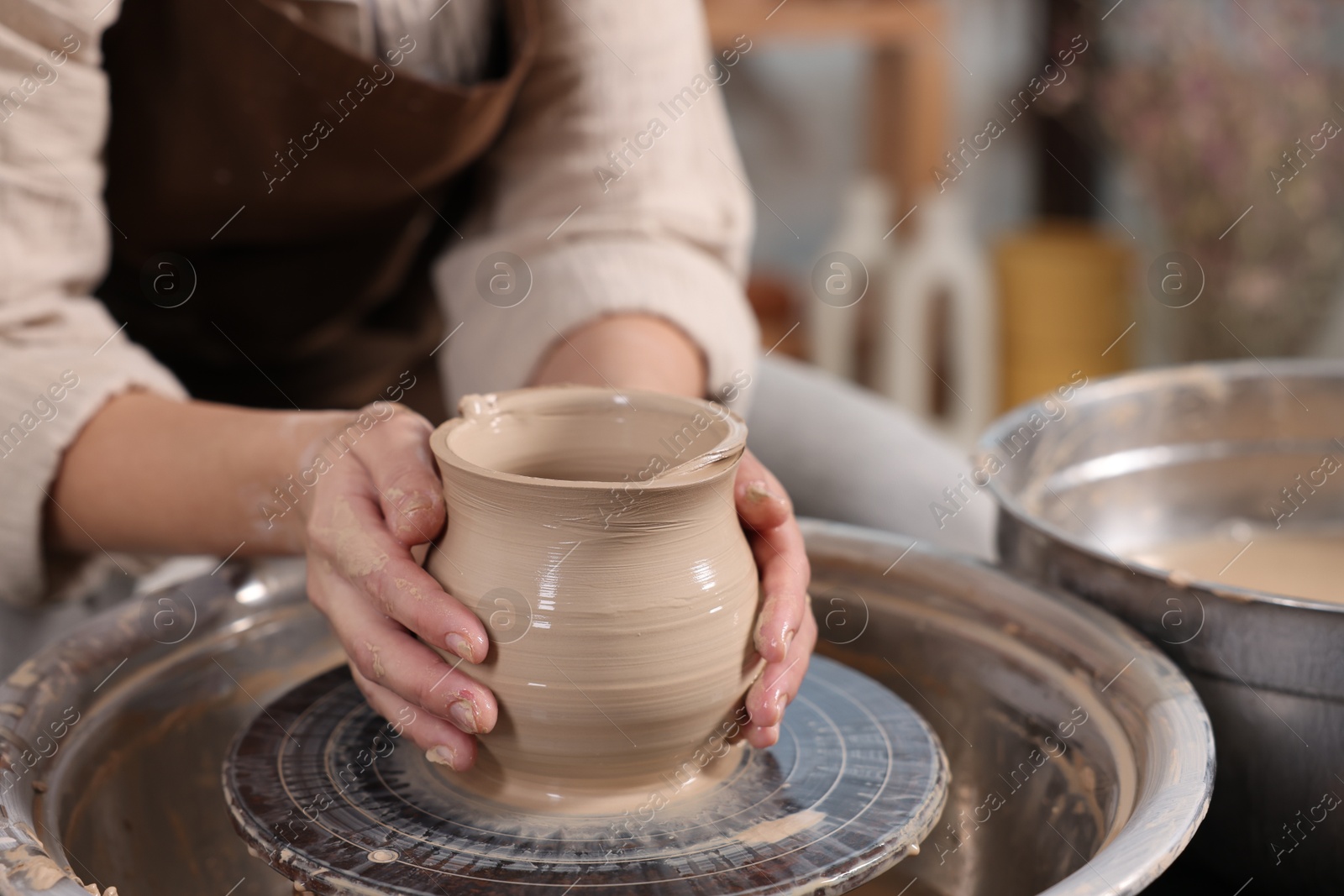 Photo of Hobby and craft. Woman making pottery indoors, closeup