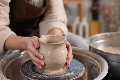 Photo of Hobby and craft. Woman making pottery indoors, closeup