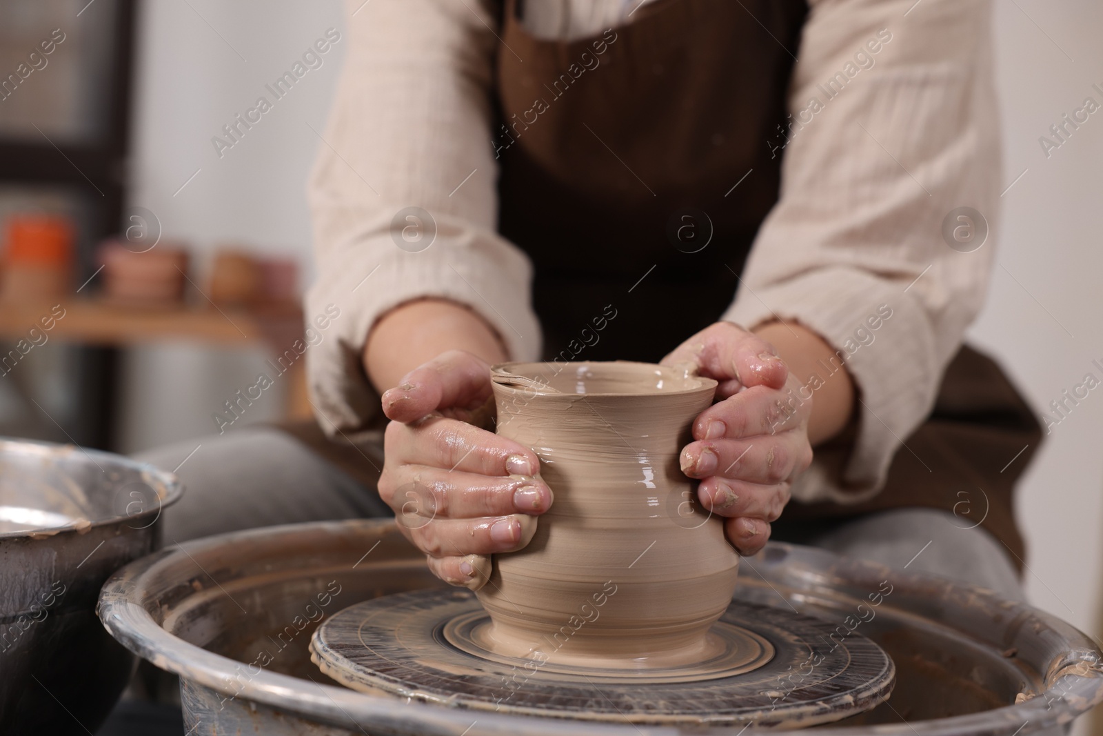 Photo of Hobby and craft. Woman making pottery indoors, closeup