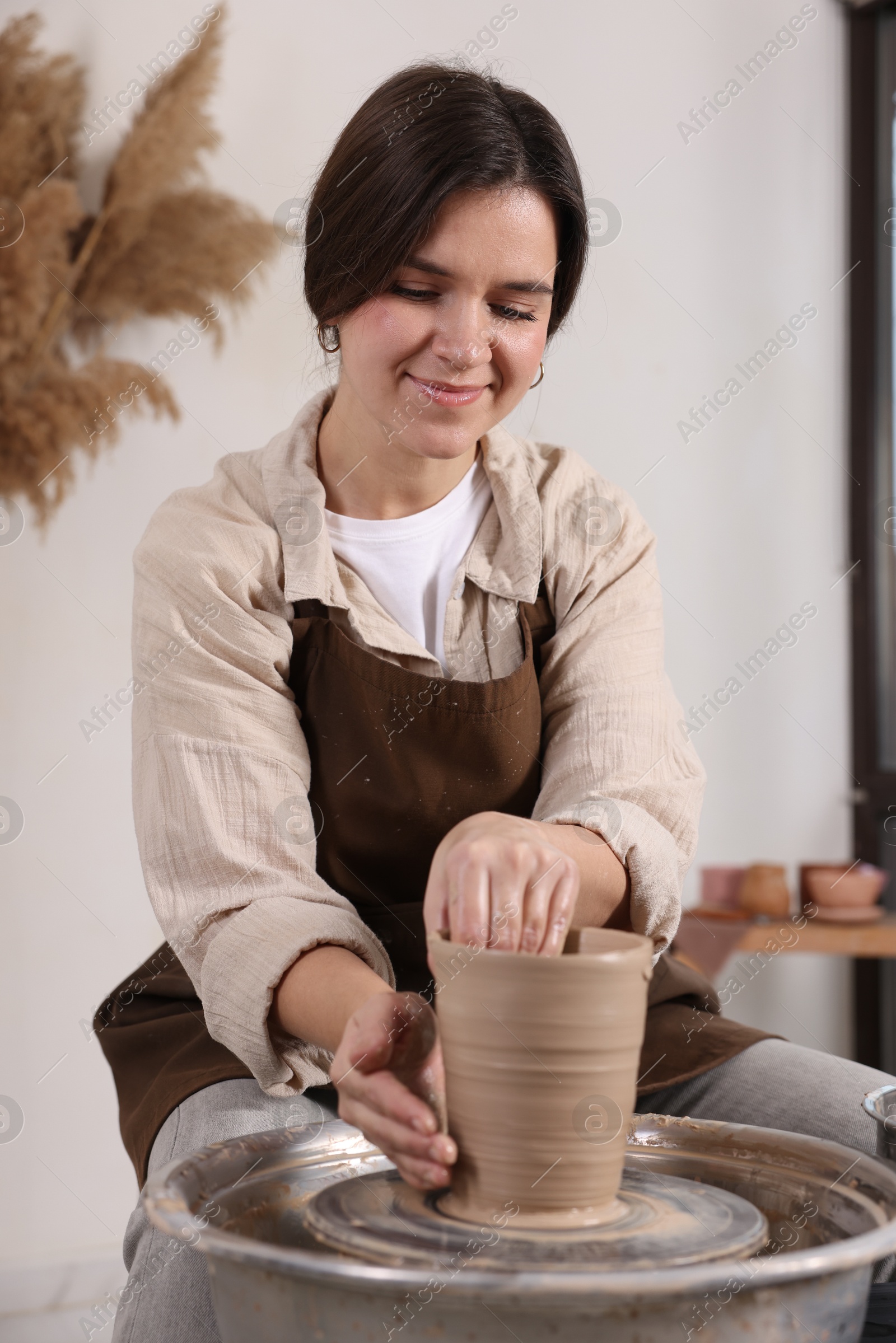 Photo of Hobby and craft. Woman making pottery indoors