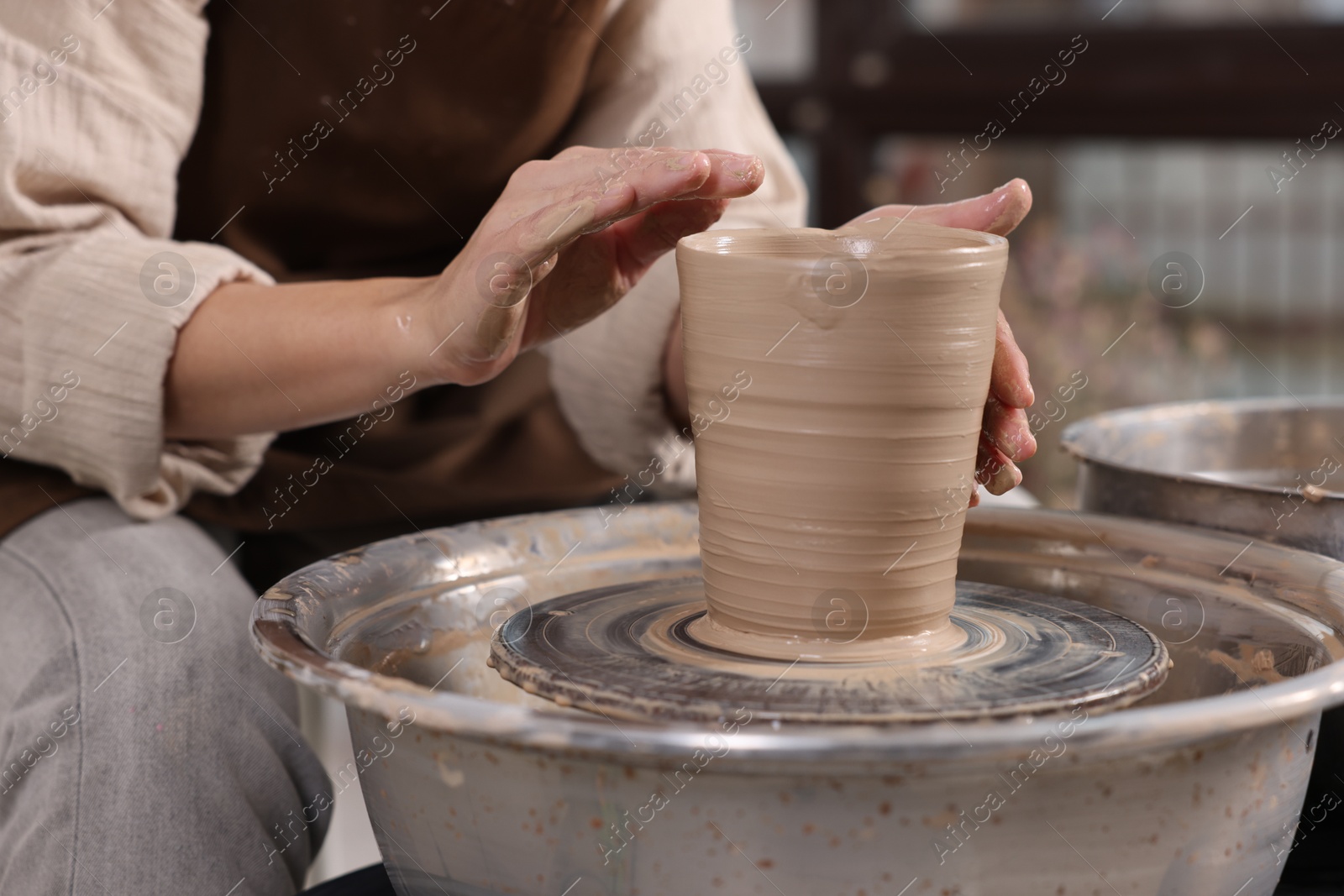 Photo of Hobby and craft. Woman making pottery indoors, closeup