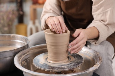 Photo of Hobby and craft. Woman making pottery indoors, closeup