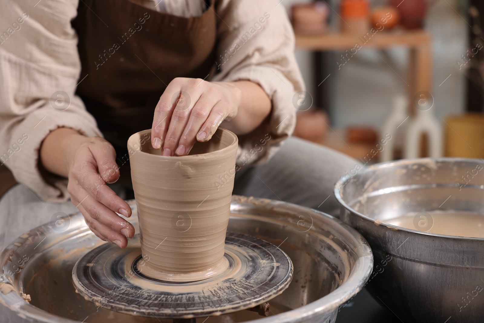 Photo of Hobby and craft. Woman making pottery indoors, closeup