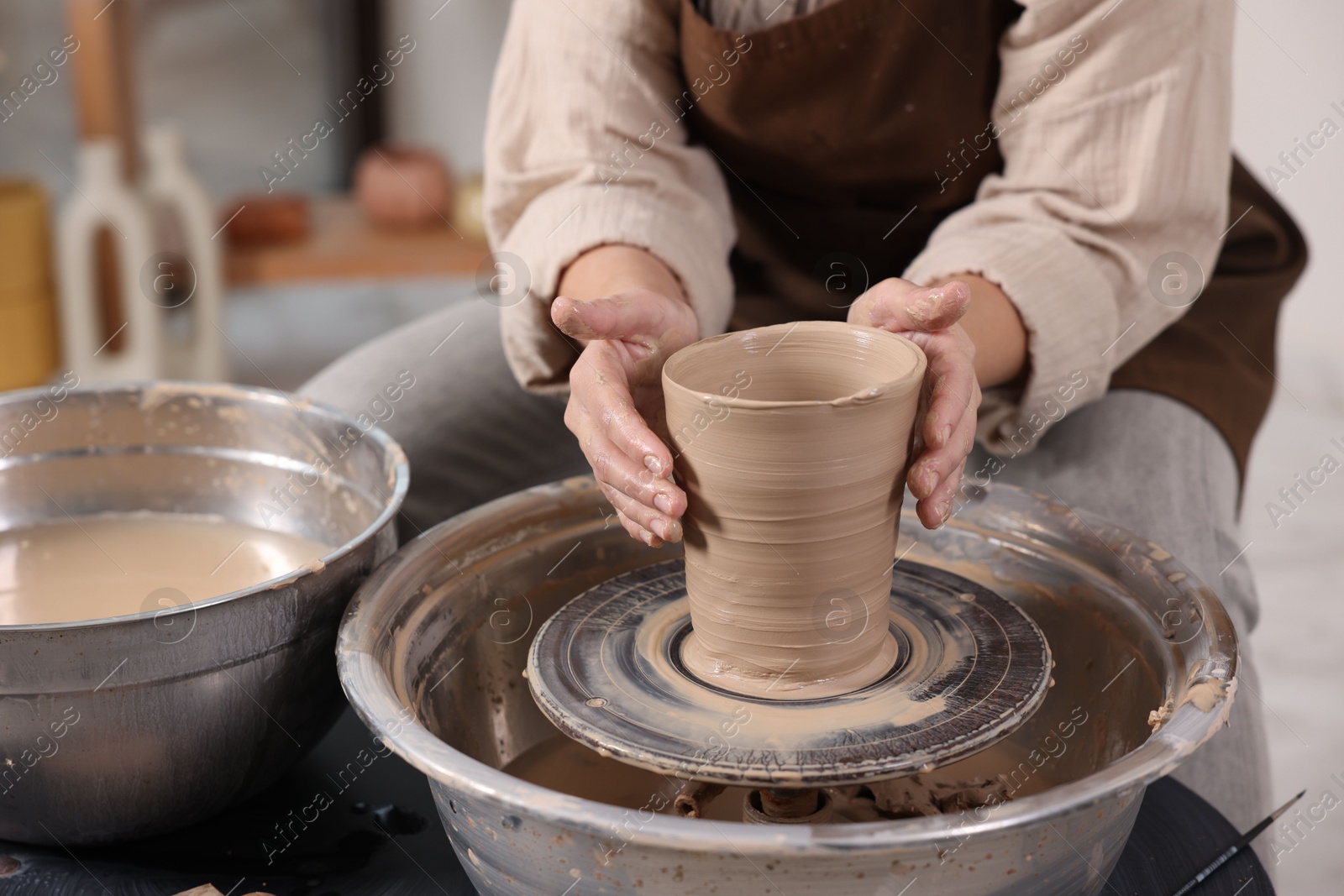 Photo of Hobby and craft. Woman making pottery indoors, closeup