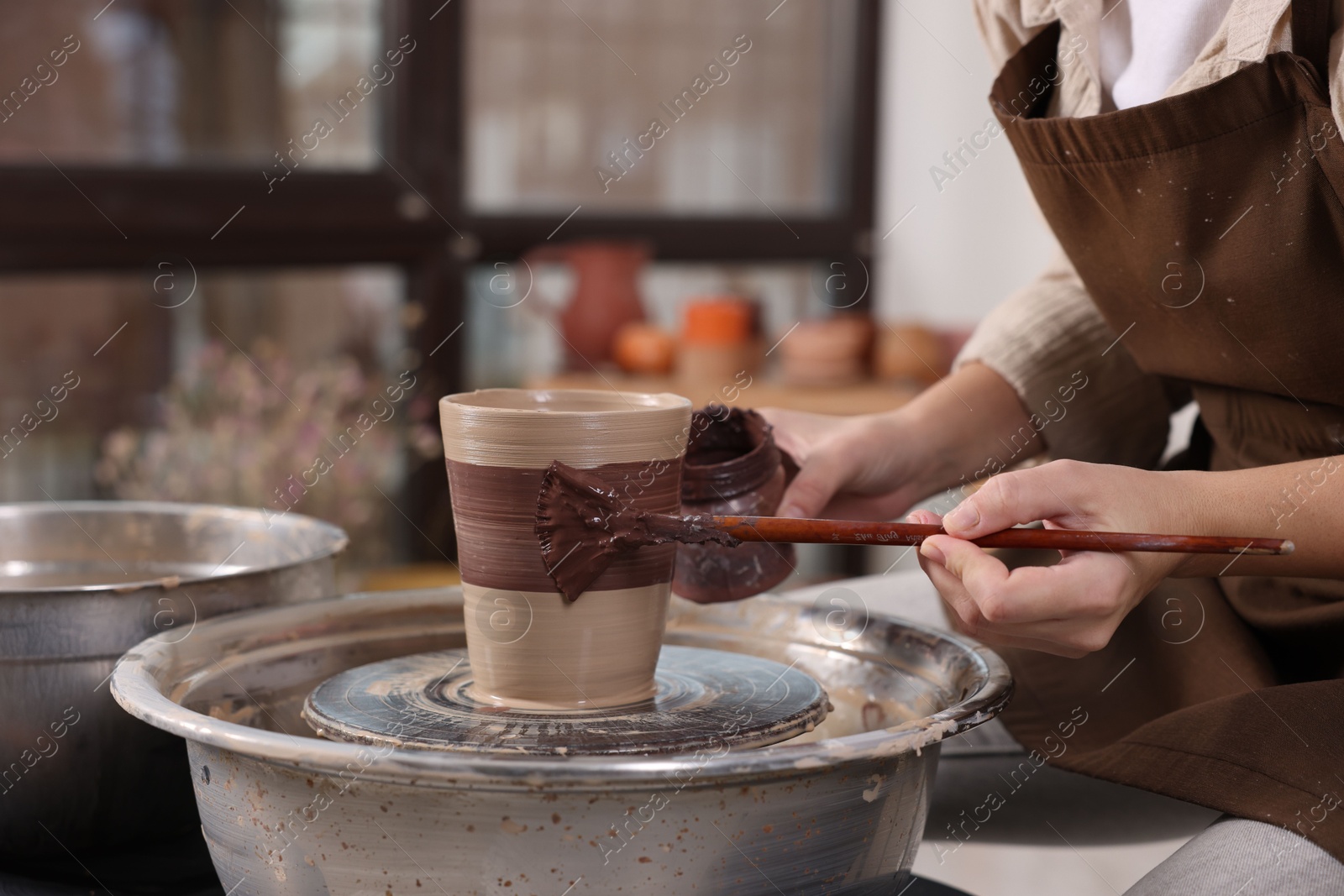 Photo of Hobby and craft. Woman making pottery indoors, closeup