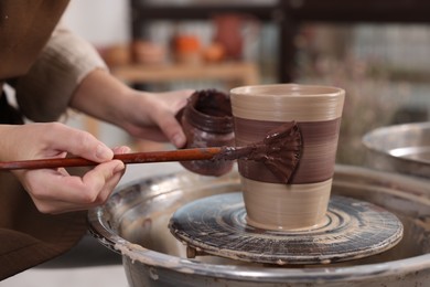 Photo of Hobby and craft. Woman making pottery indoors, closeup