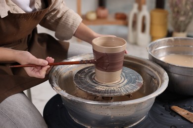 Photo of Hobby and craft. Woman making pottery indoors, closeup