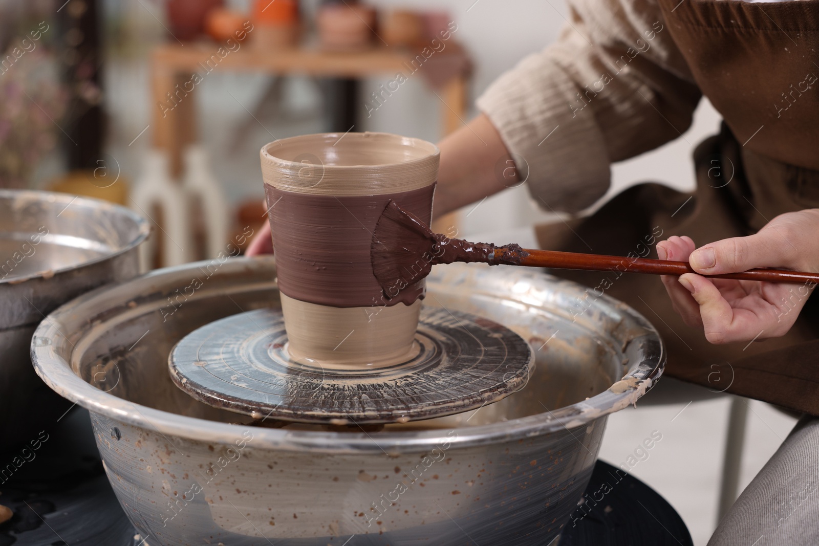 Photo of Hobby and craft. Woman making pottery indoors, closeup