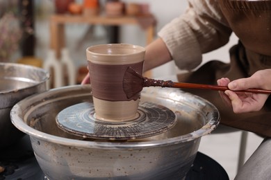 Photo of Hobby and craft. Woman making pottery indoors, closeup