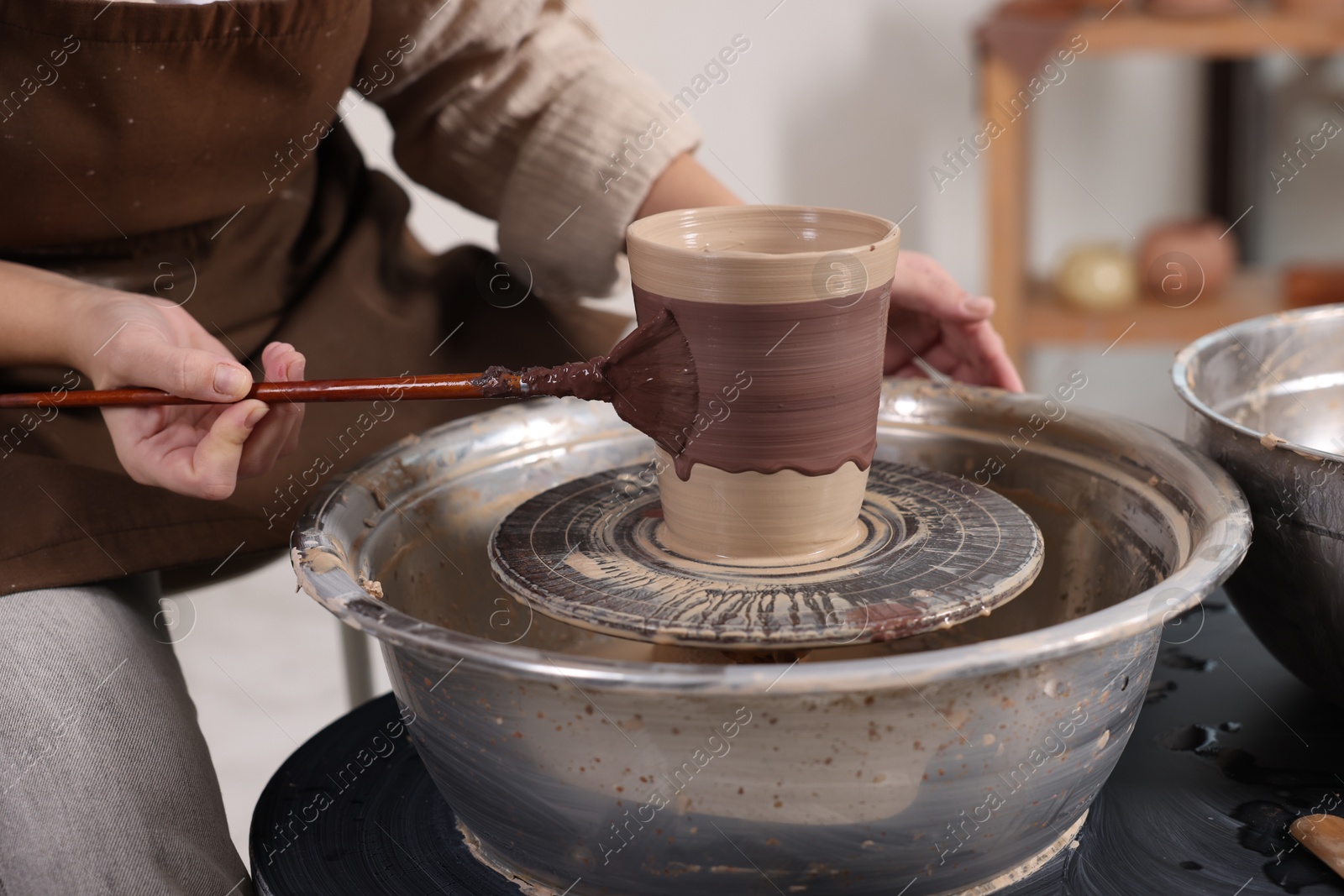 Photo of Hobby and craft. Woman making pottery indoors, closeup