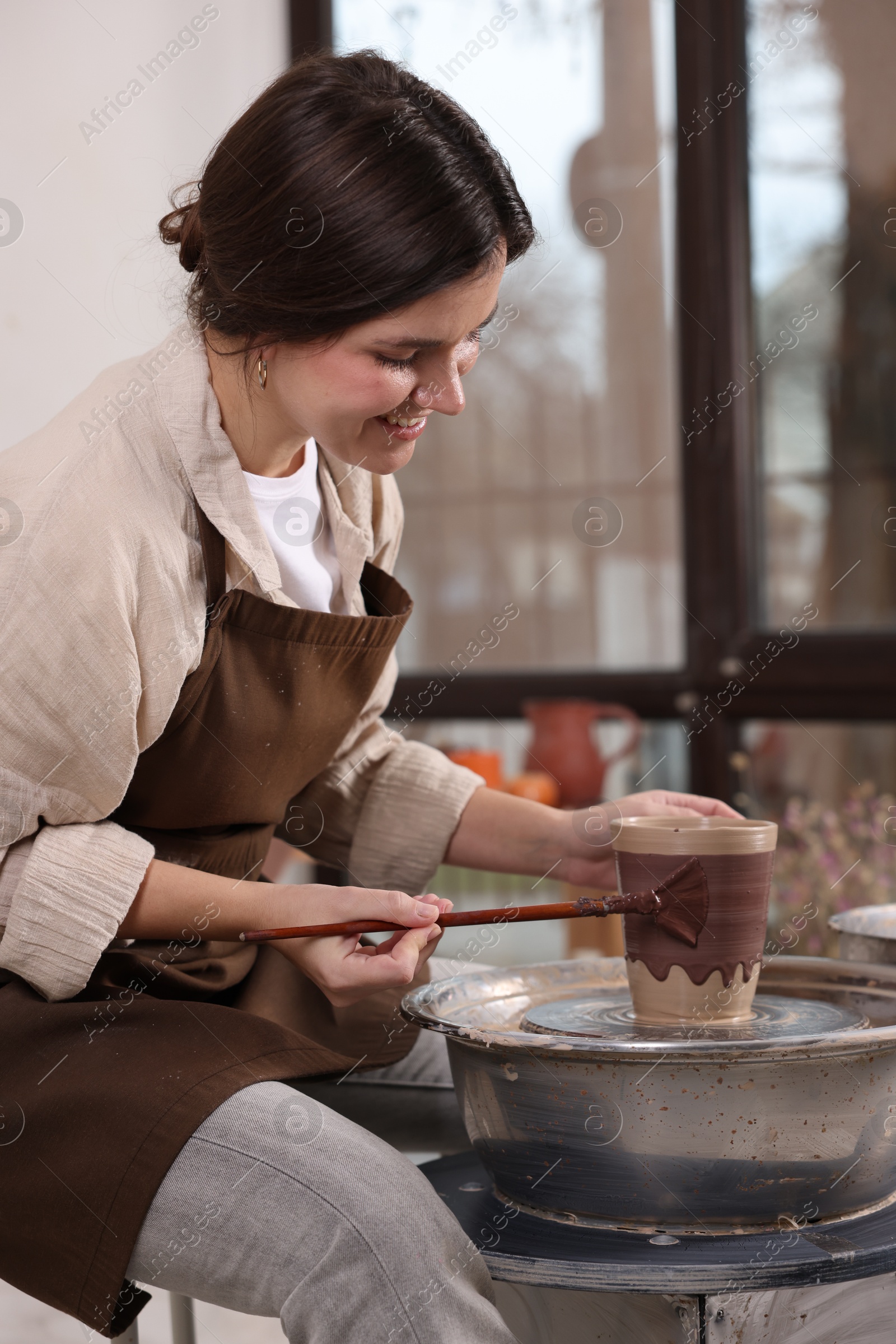 Photo of Hobby and craft. Smiling woman making pottery indoors