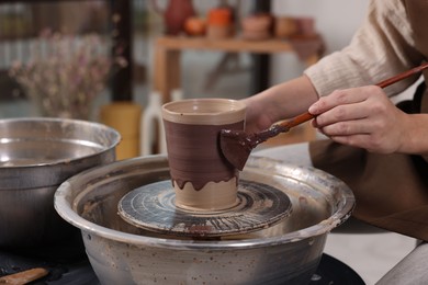 Photo of Hobby and craft. Woman making pottery indoors, closeup