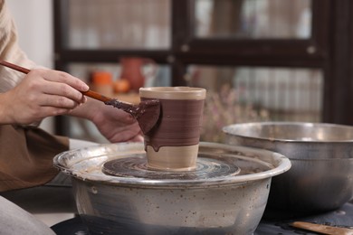 Photo of Hobby and craft. Woman making pottery indoors, closeup