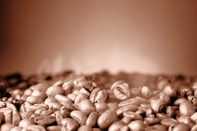 Image of Coffee beans on brown gradient background, closeup. Mocha mousse - color of 2025 year