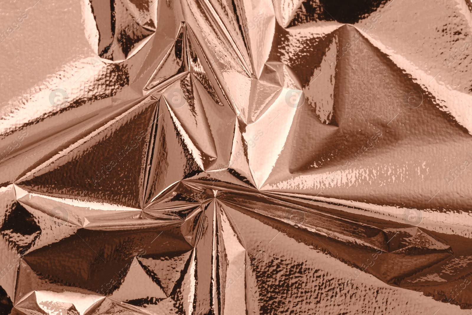 Image of Shiny foil in mocha mousse shade, top view. Trendy color of 2025 year