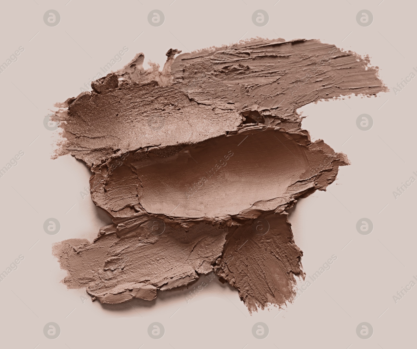 Image of Lipstick samples in mocha mousse shade on beige background, top view. Trendy color of 2025 year