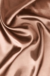 Image of Silk fabric in mocha mousse shade, closeup. Trendy color of 2025 year