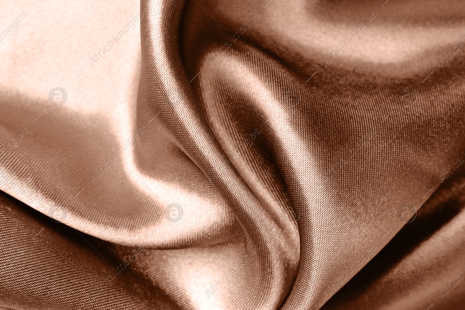 Image of Silk fabric in mocha mousse shade, closeup. Trendy color of 2025 year