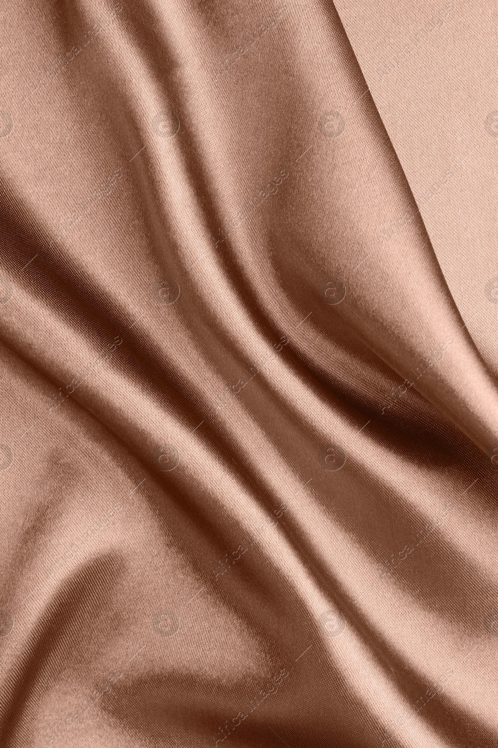 Image of Silk fabric in mocha mousse shade, closeup. Trendy color of 2025 year