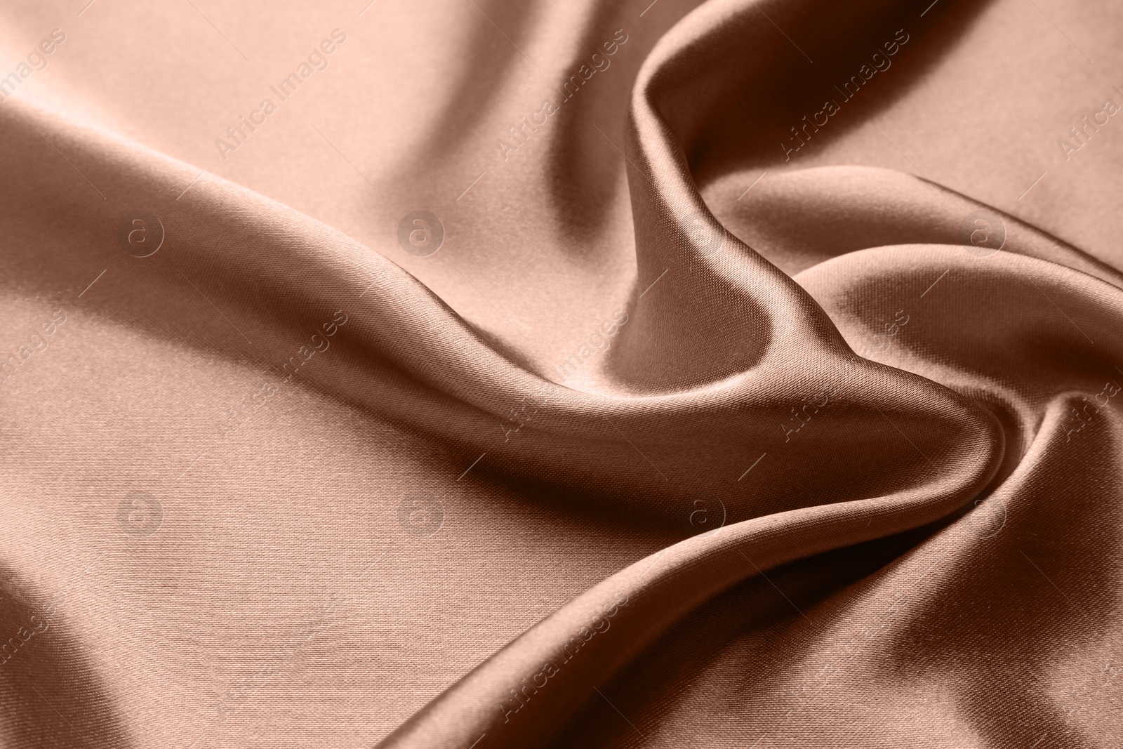 Image of Silk fabric in mocha mousse shade, closeup. Trendy color of 2025 year