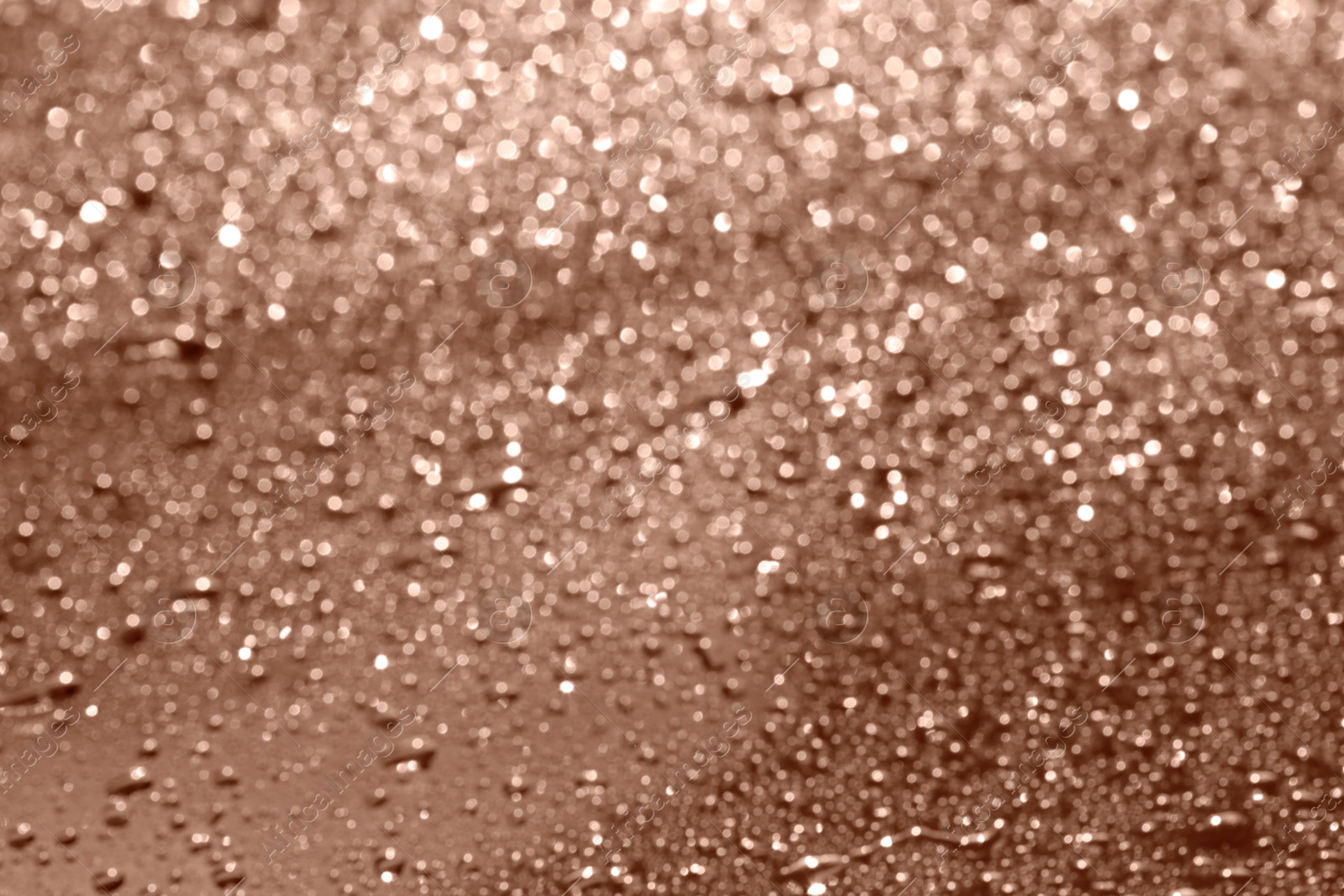 Image of Water drops on glass surface, closeup. Toned in trendy color of 2025 year - mocha mousse