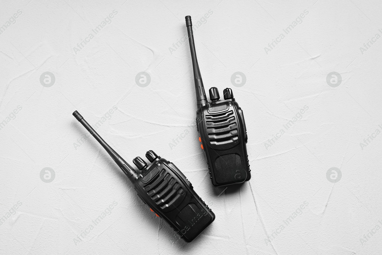 Photo of Walkie talkies on white table, top view