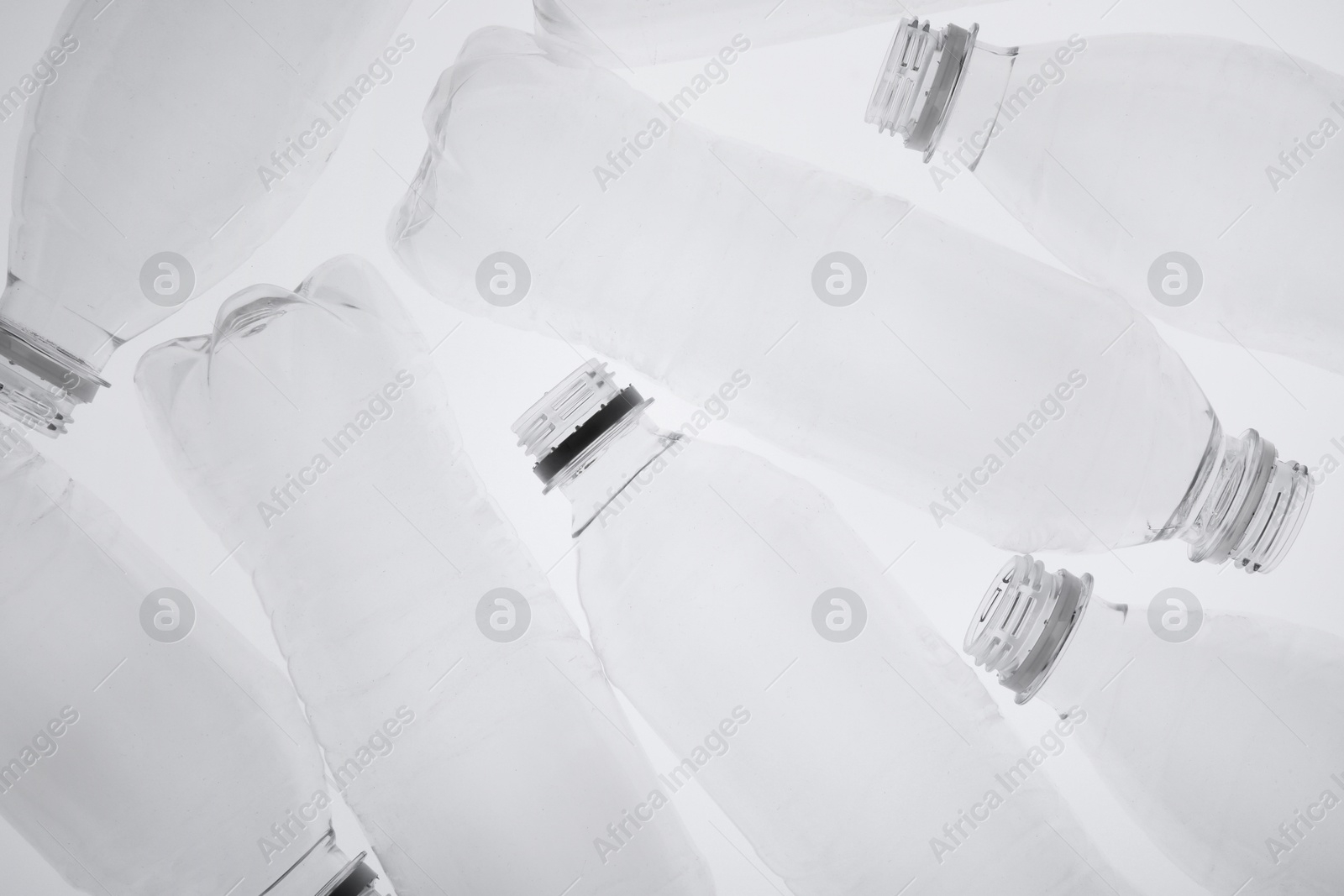 Photo of Empty plastic bottles on white background, top view