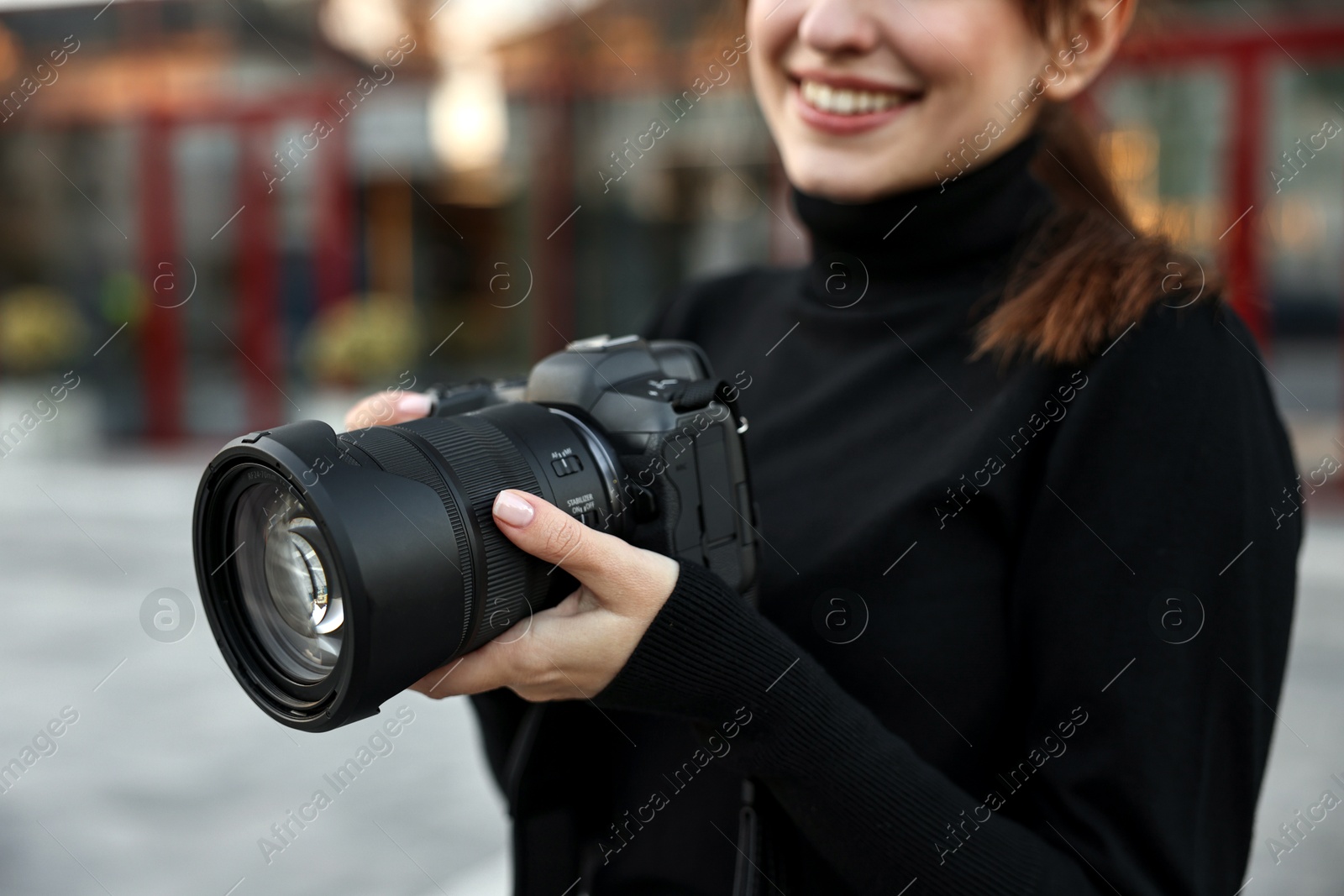 Photo of Professional photographer with digital camera outdoors, closeup