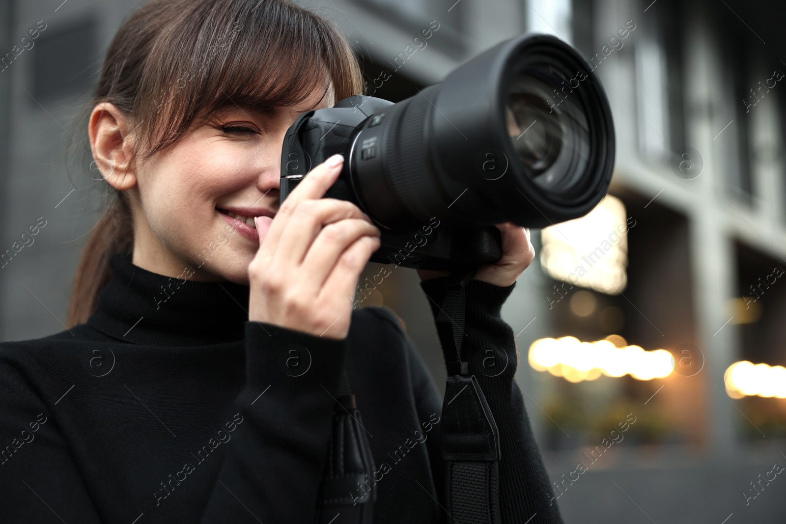 Photo of Professional photographer taking picture with camera outdoors