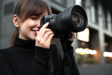 Photo of Professional photographer taking picture with camera outdoors