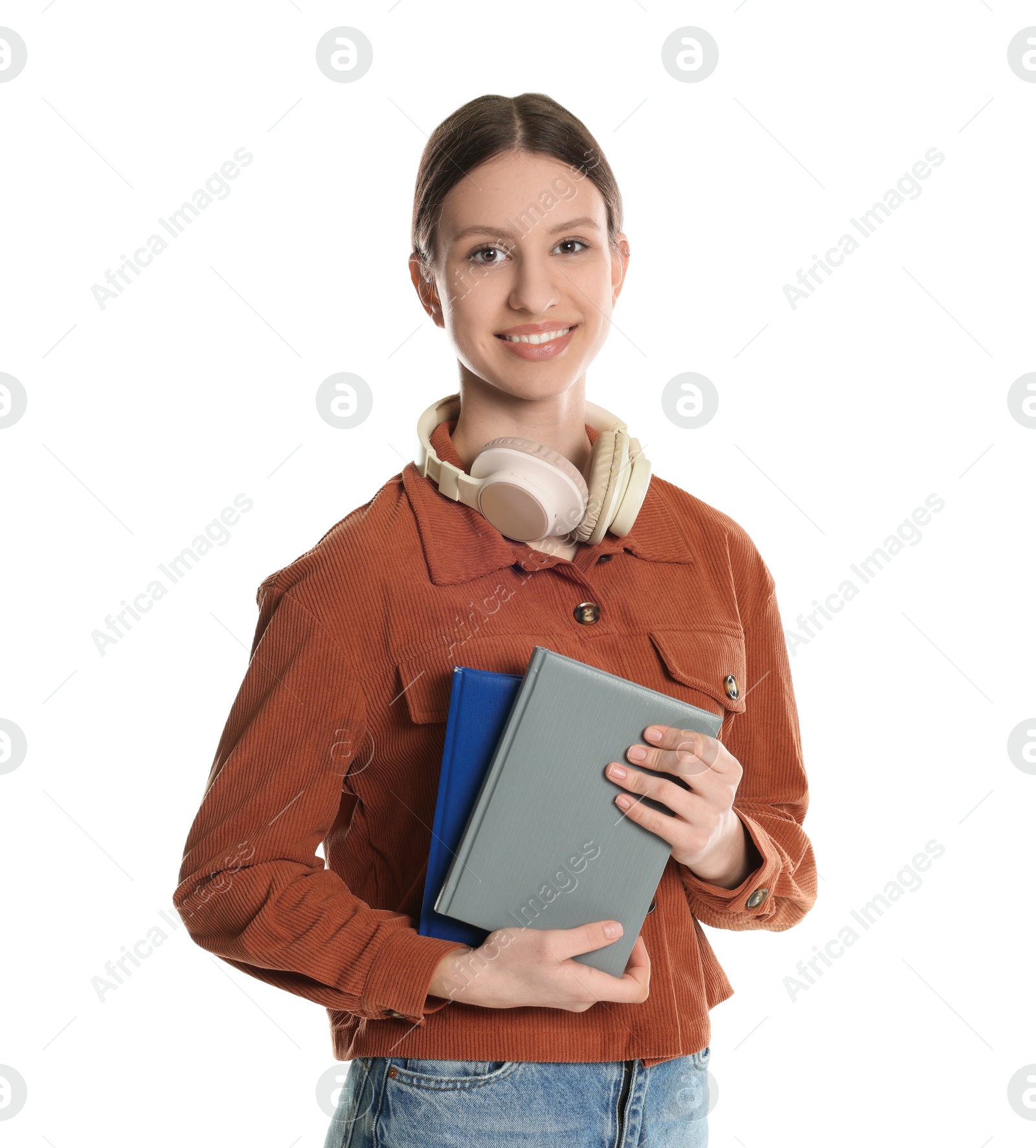 Photo of Portrait of smiling teenage girl with books and headphones on white background