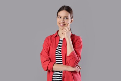 Photo of Portrait of smiling teenage girl on grey background