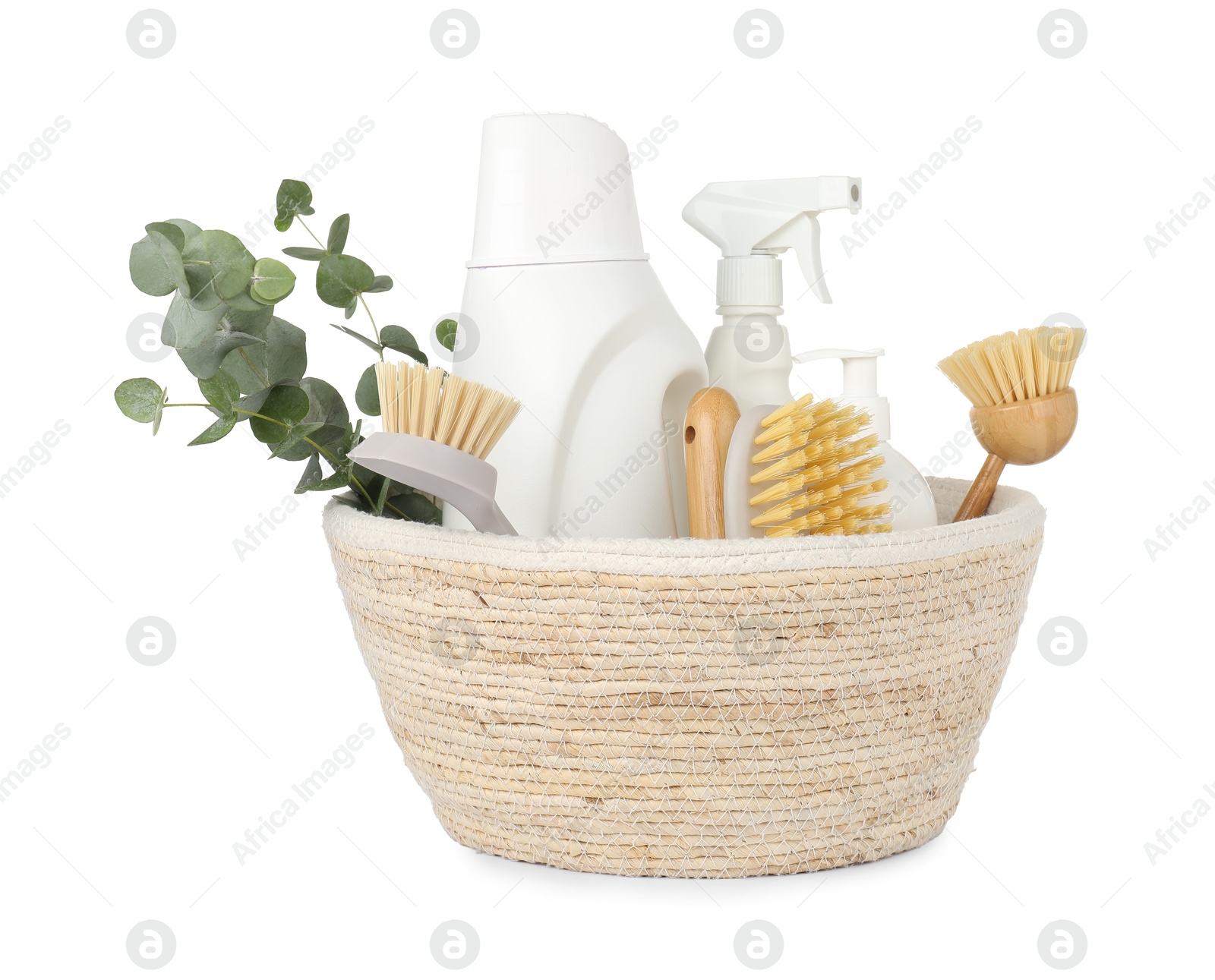 Photo of Eco-friendly cleaning products, supplies and eucalyptus branches in wicker basket isolated on white