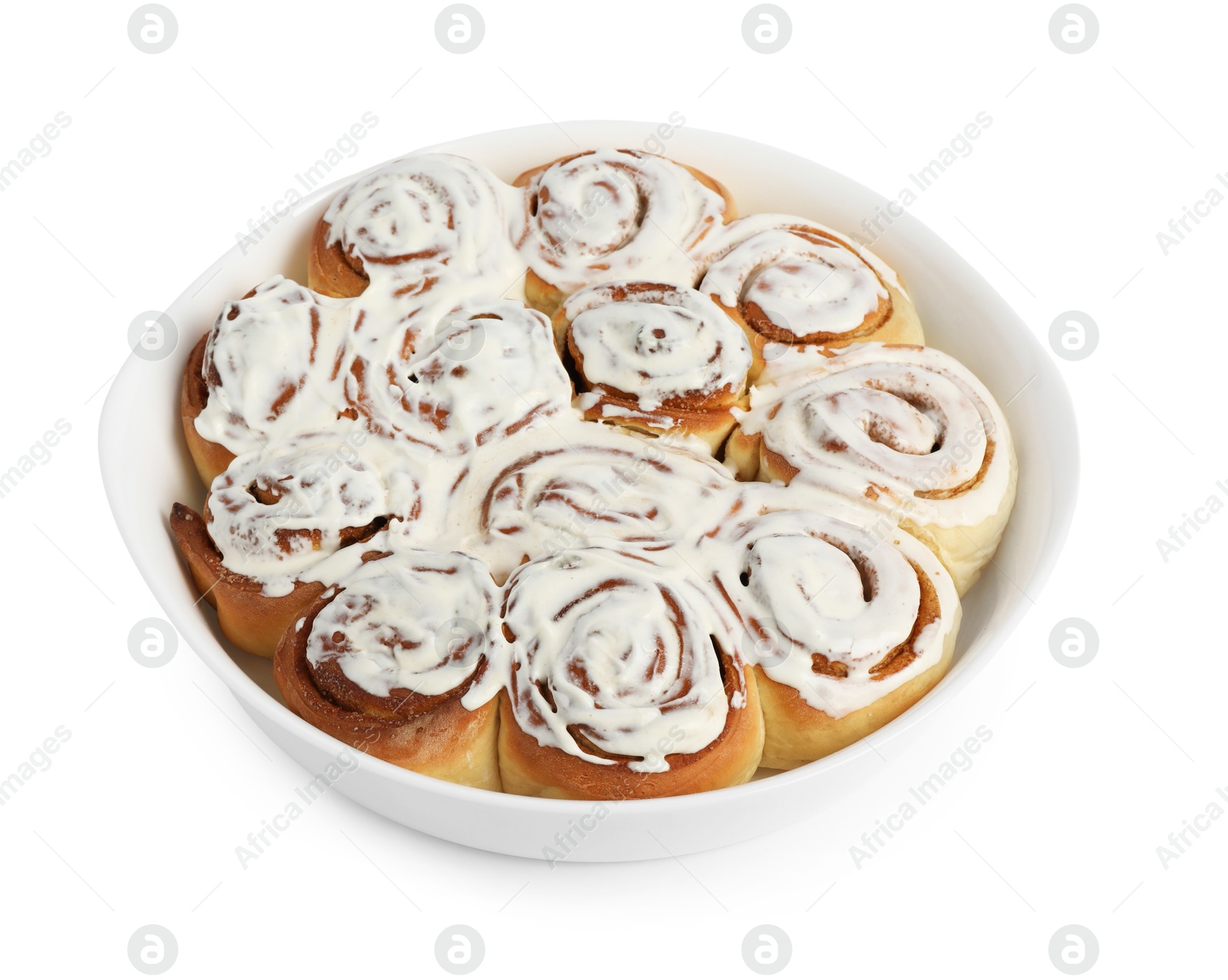 Photo of Delicious frosted cinnamon rolls in baking dish isolated on white