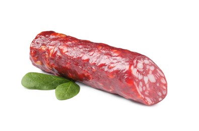 Photo of Piece of delicious dry cured sausage with basil isolated on white