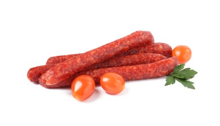 Photo of Many thin dry cured sausages with parsley and tomatoes isolated on white