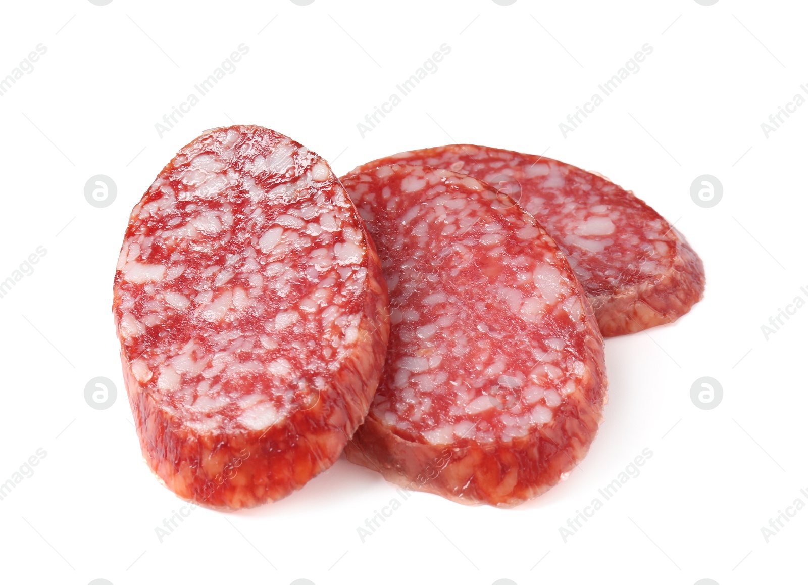 Photo of Pieces of delicious dry cured sausage isolated on white