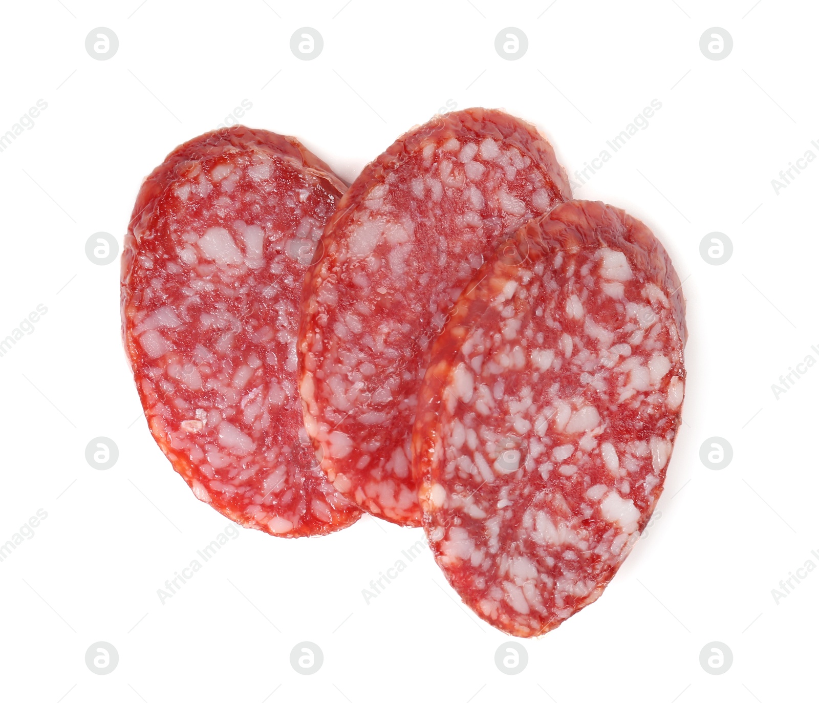 Photo of Pieces of delicious dry cured sausage isolated on white, top view