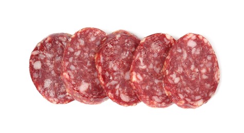 Photo of Pieces of delicious dry cured sausage isolated on white, top view